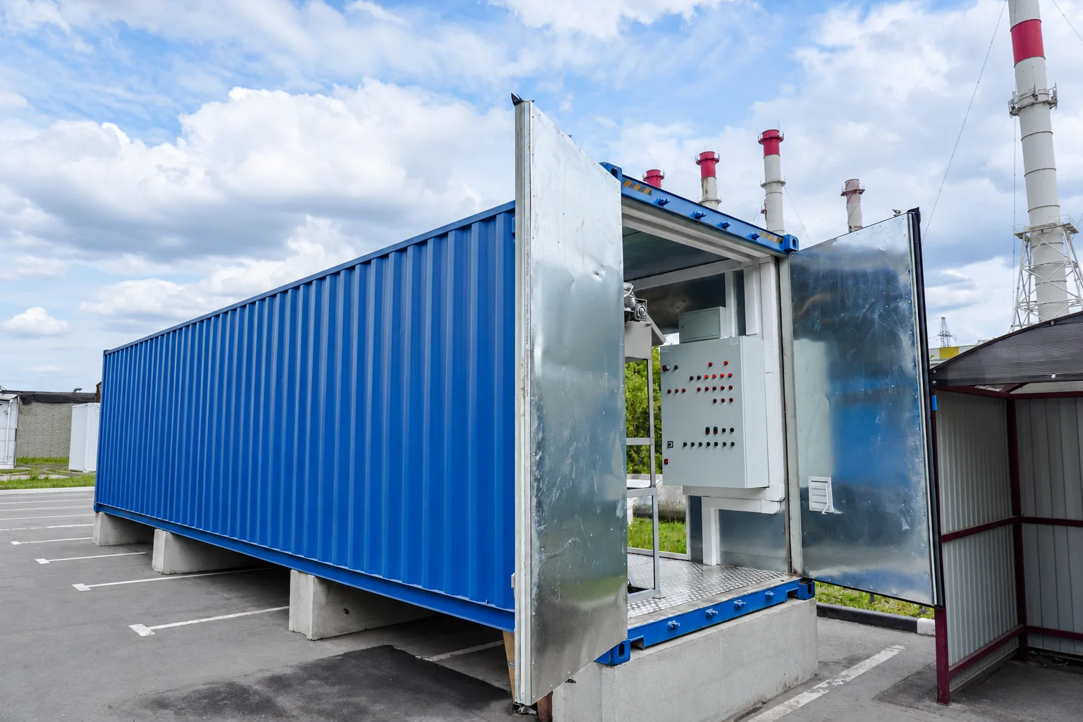 Exterior of a blue containerised treatment module with open service doors